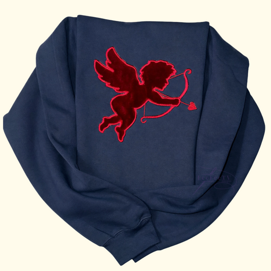 flat lay of a black sweatshirt with a RED cupid design on a white background