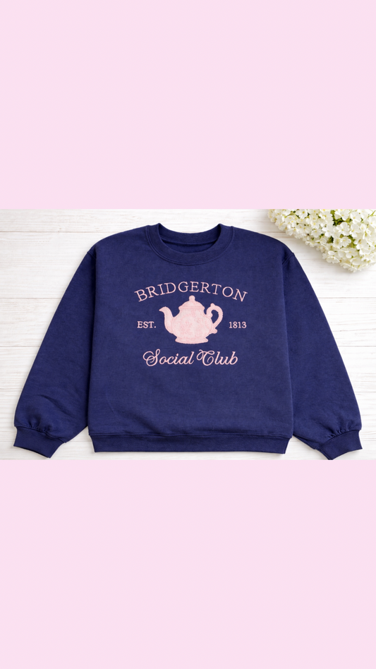 a pink chinoiserie teapot on a blue sweatshirt romance book