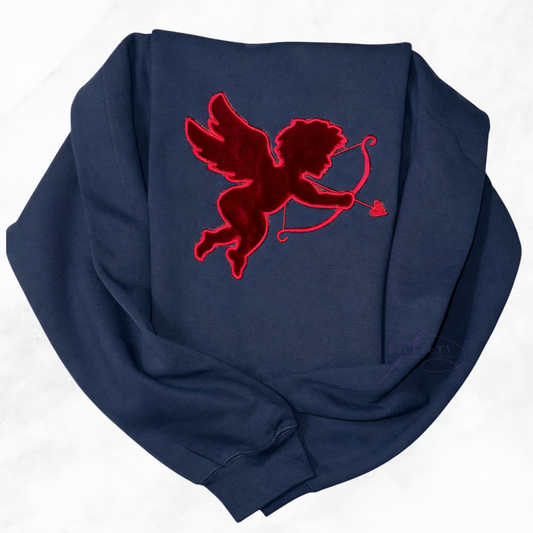 flat lay of a black sweatshirt with a RED cupid design on a white background