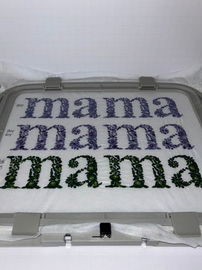 Embroidery hoop with floral mama text embroidery design on a white background