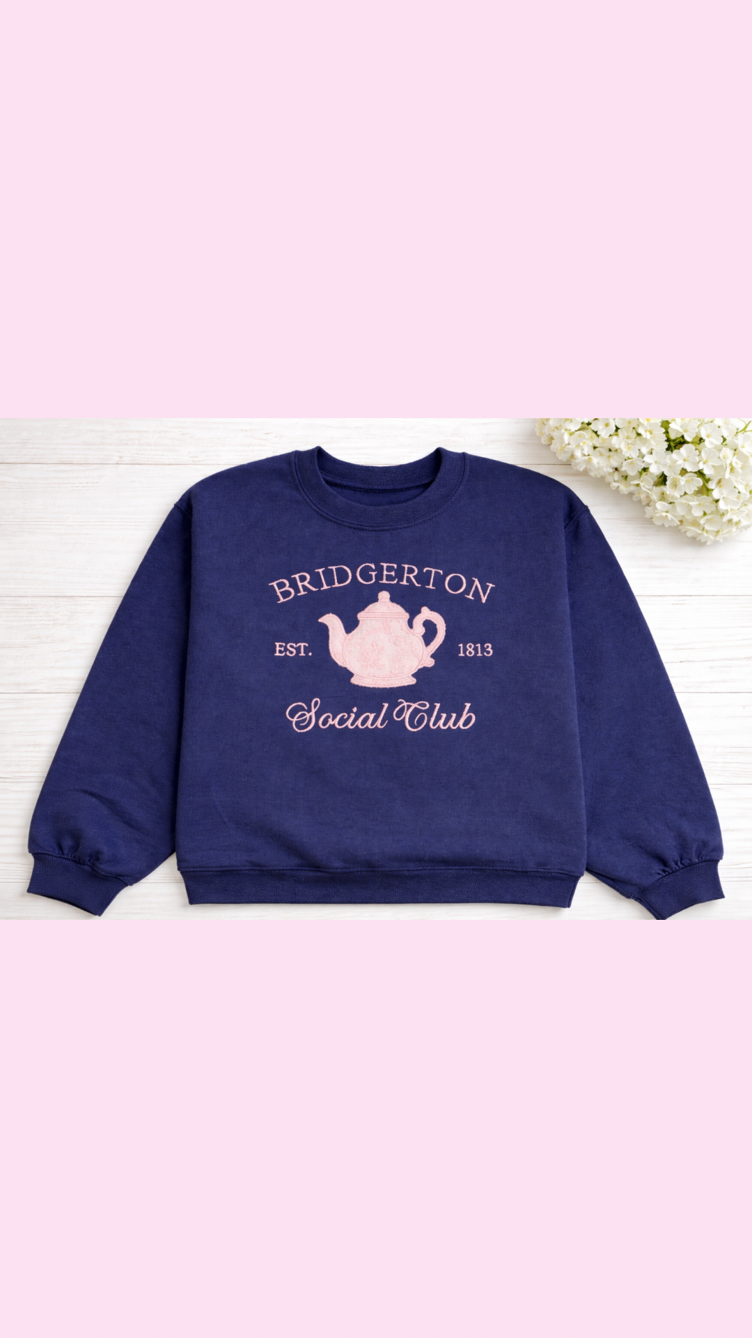 a pink chinoiserie teapot on a blue sweatshirt romance book