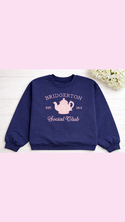 a pink chinoiserie teapot on a blue sweatshirt romance book
