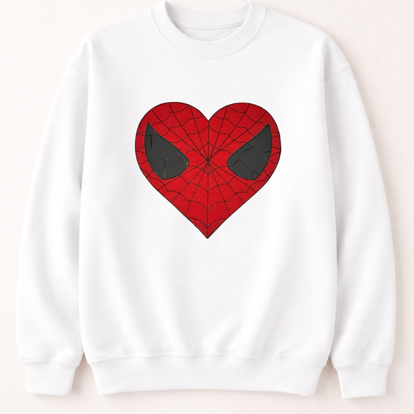 White sweatshirt with a red heart-shaped spider web design on a beige background