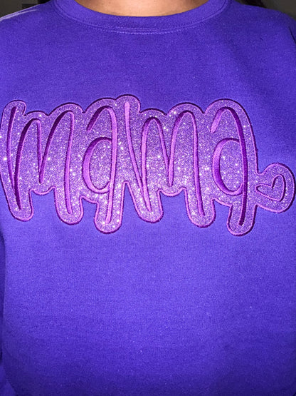 female wearing a Purple sweatshirt with 'MAMA' in glittery embroidery and HTV