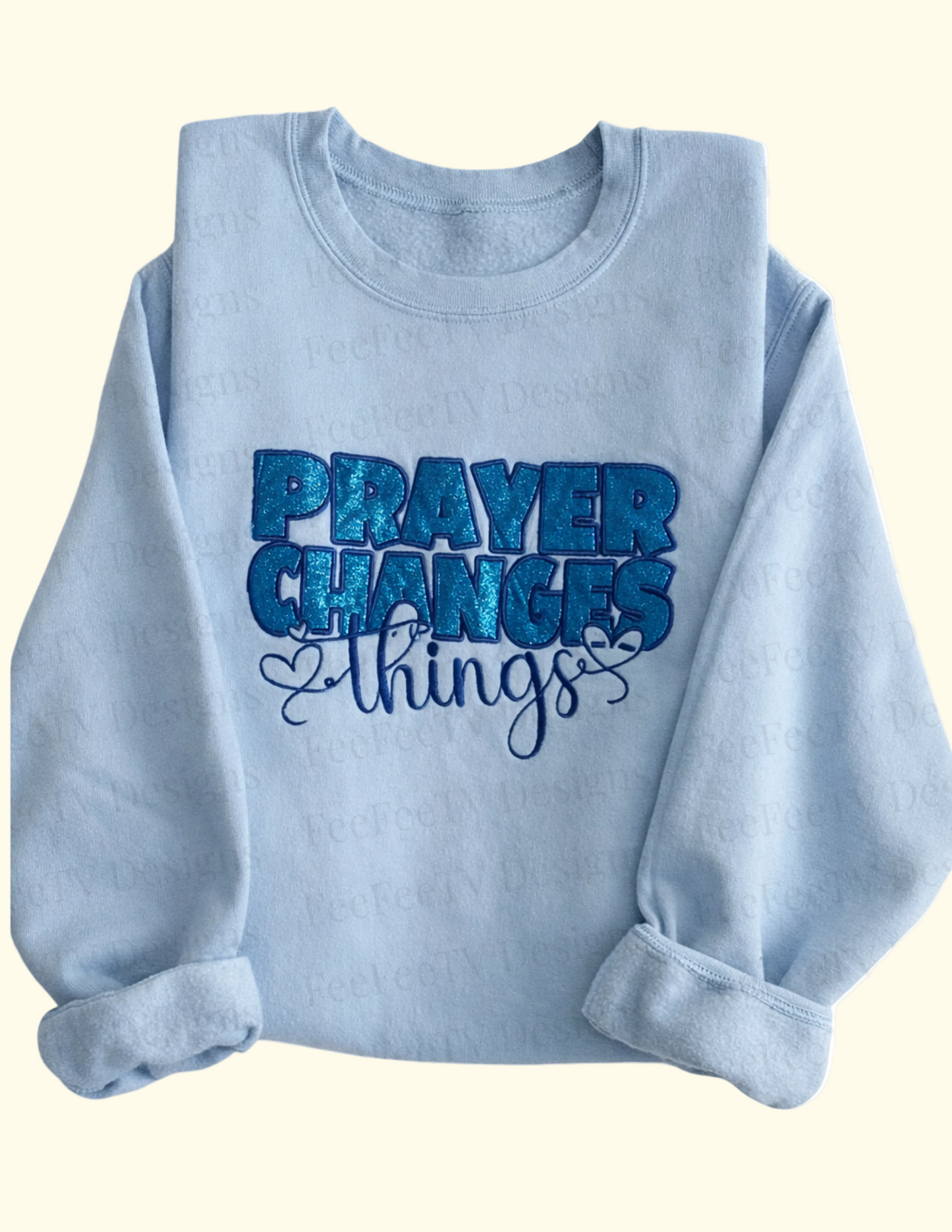 Light blue sweatshirt with 'PRAYER CHANGES THINGS' text on a white background