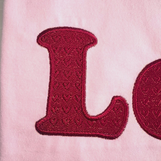 close up video of embroidery love embossed hearts t-shirt 
