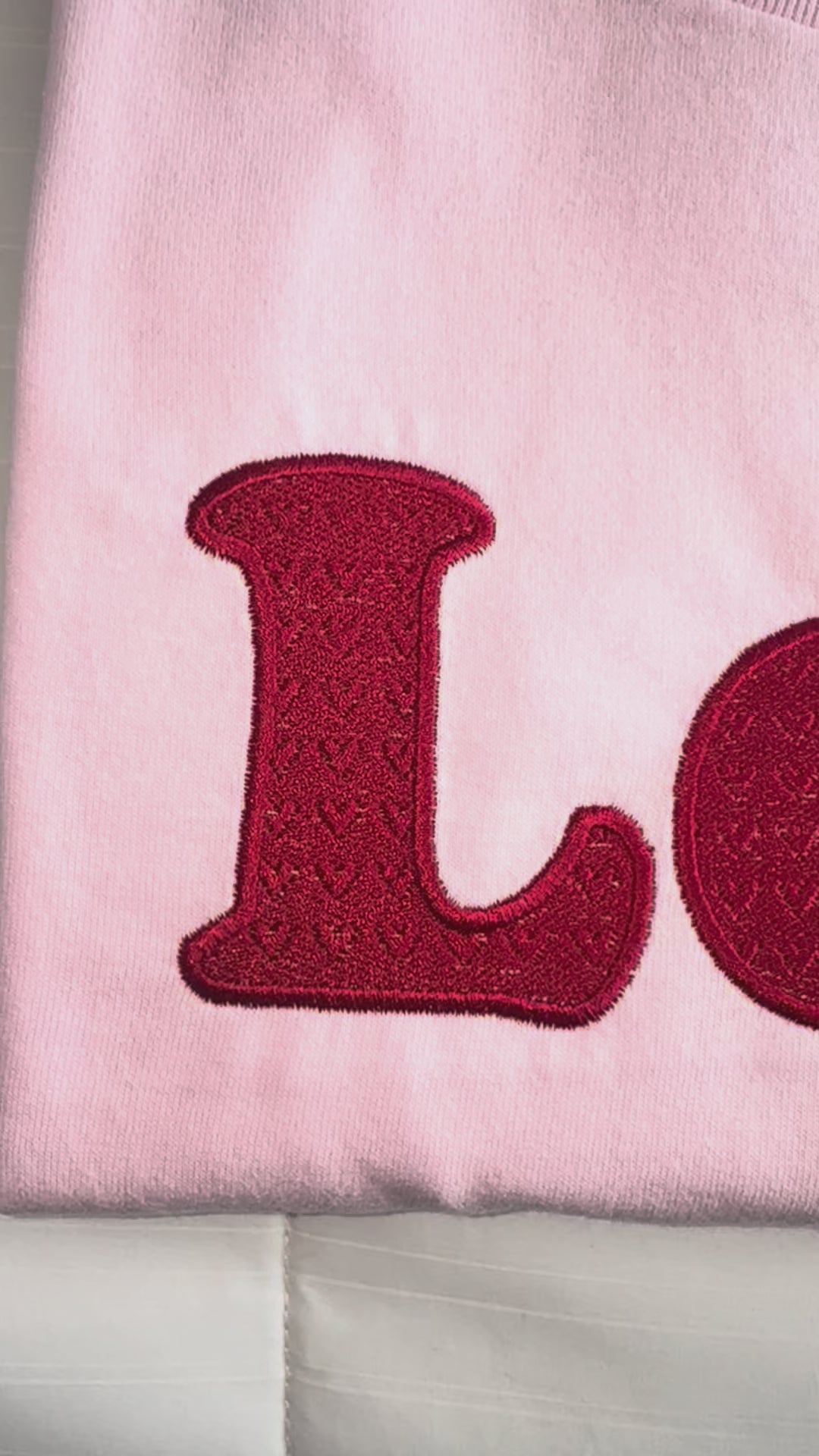 close up video of embroidery love embossed hearts t-shirt 