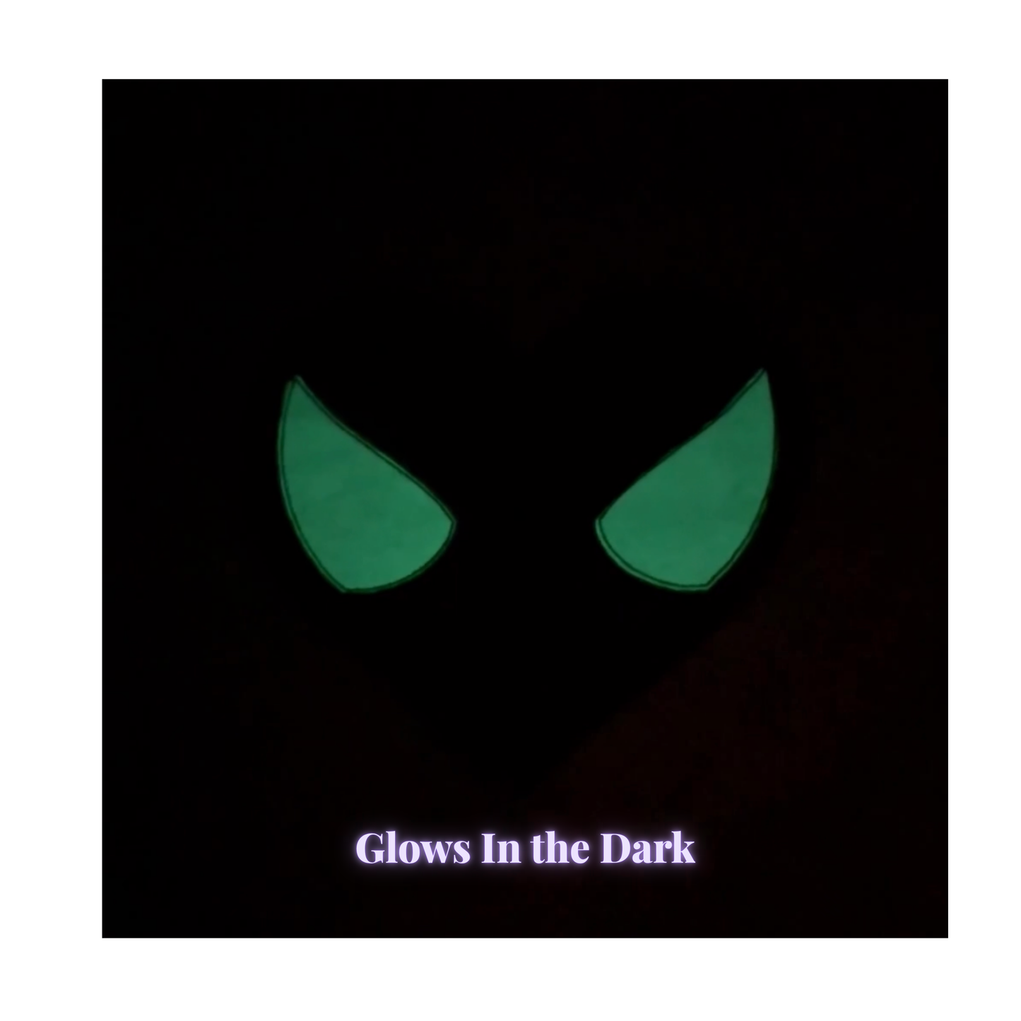 glowing green eye shapes, shown against a dark background with the text 'Glows In the Dark' at the bottom.