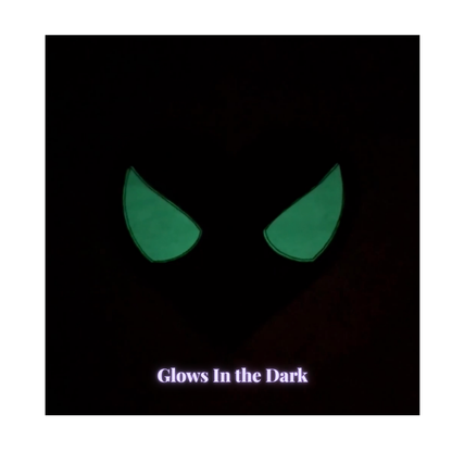 glowing green eye shapes, shown against a dark background with the text 'Glows In the Dark' at the bottom.